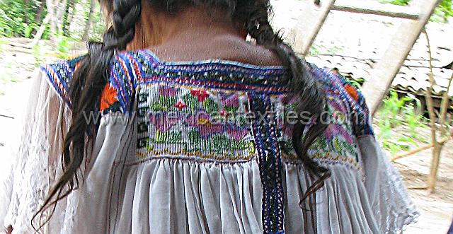 Untitled-1.jpg - A close up of the cross stitching on the back of her blouse.